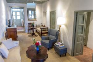 a living room with a couch and a table at Patmos Traditional House Chora near the Monastery in Patmos