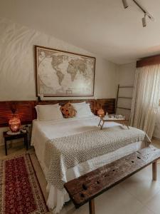 a bedroom with a large bed with a map on the wall at Casa Amada in Arraial d'Ajuda
