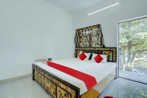 a bedroom with a bed and a large window at Flagship Hotel Pragya 3 New in Raipur