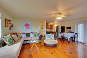 a living room with a couch and a table at Breezy Kailua-Kona Bungalow with Lanai and Ocean View! in Kailua-Kona
