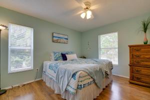 a bedroom with a bed and a ceiling fan at Crystal River Vacation Rental on Canal! in Crystal River