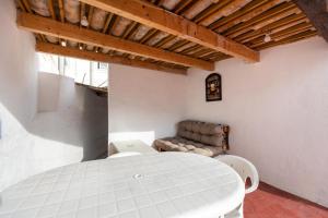 ein weißes Zimmer mit einem Tisch und einem Sofa in der Unterkunft Casa turística Cunit in Cunit