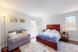 a bedroom with a bed and a couch at White Oaks in Branford