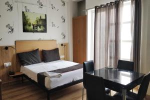 a bedroom with a bed and a dining room table at Townhouse Kachnar House Vikas Nagar in Hasanganj