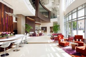 a lobby with chairs and tables in a building at Residence Inn by Marriott Los Angeles L.A. LIVE in Los Angeles