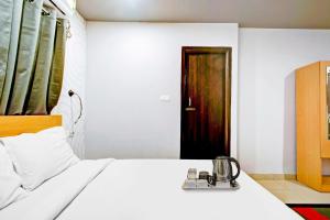 1 dormitorio con 1 cama y puerta de madera en Super Townhouse 406 Volga Homes en Kāhārpāra