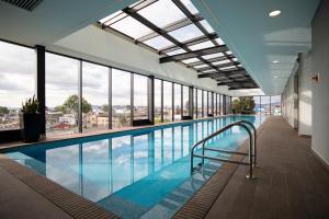 a swimming pool with a view of a building at 72 HUB Apartments - Great View - Gym - Rooftop in Bogotá