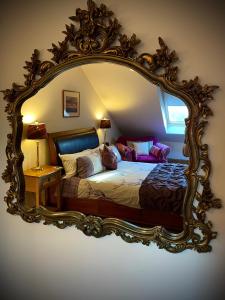 a bedroom with a large mirror with a bed in it at Mulberry in Nairn