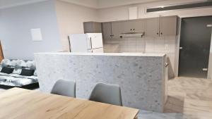 a kitchen with a counter with chairs and a table at Villa Maria in Parga