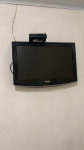a small television sitting on a white wall at Pousada Maceio Praia in Maceió +12 photos