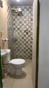 a bathroom with a toilet and a shower at Pousada Maceio Praia in Maceió