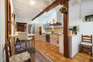 a kitchen with a table and chairs in a room at House Ca Na Polida in Alcudia