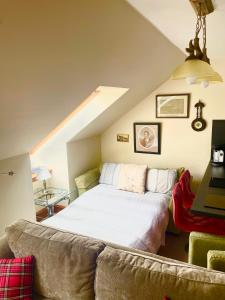a bedroom with a bed and a couch at Red Stag Apartment in Nairn