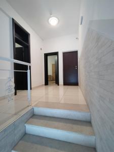 a staircase in a building with two doors and windows at Lovely Home Rooms & Apartments in Mostar