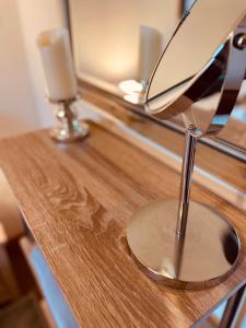 a desk with a chair on a table with two candles at Grey Stag Apartment in Nairn