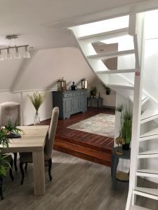 a dining room with a table and a staircase at B&B Bij Arjan in Terborg