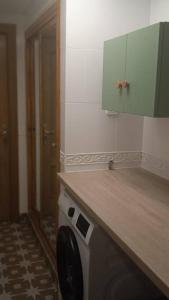 a kitchen with a washing machine under a counter at Apartamento Bayyana in Baena +4 photos