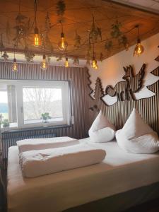 a bedroom with two beds and lights on the wall at Apartment Fabelwald Black Forest in Schonach