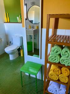 a doll house bathroom with a toilet and a mirror at Glamping Bed and Breakfast Finca Alegria de la Vida in Pizarra