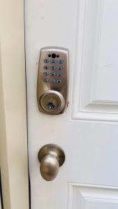 a door with a lock and a knob on it at The Home Sweet Home in Winnipeg