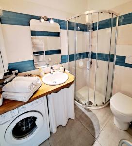 a bathroom with a washing machine and a shower at Sea view studio terrasse Cap Martin/Monaco in Roquebrune-Cap-Martin