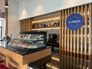 a restaurant with a counter with food on display at Holiday Inn Express - Ankara - Airport by IHG in Ankara