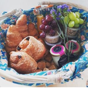 a basket filled with pastries and fruit on a table at Pilgrims Nap in Rainham
