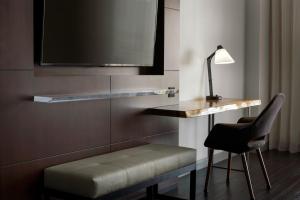 a room with a desk and a chair and a television at Visalia Marriott at the Convention Center in Visalia