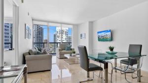 a living room with a glass table and chairs at Icon Brickell 1 bed Miami 32nd in Miami