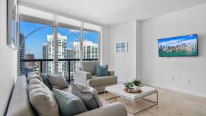 a living room with a couch and a large window at Icon Brickell 1 bed Miami 32nd in Miami