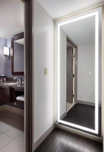 a large mirror in a bathroom with a sink at Visalia Marriott at the Convention Center in Visalia