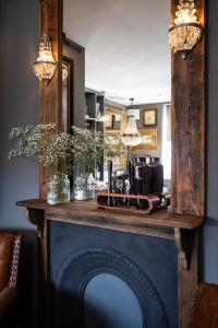 a fireplace in a living room with a counter top at The Barth Room at Cheshire Boutique Barns in Nantwich