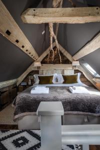 um quarto com uma cama grande e um tecto em madeira em The Barth Room at Cheshire Boutique Barns em Nantwich