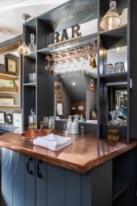 a kitchen with a counter with a sink and a mirror at The Barth Room at Cheshire Boutique Barns in Nantwich