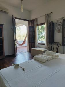 a bedroom with a large bed with two towels on it at Estancia Urbana Hotel Boutique in Río Cuarto