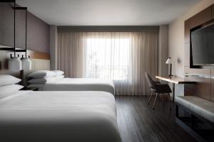 Habitación de hotel con 2 camas y escritorio en Visalia Marriott at the Convention Center, en Visalia