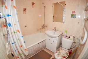 a bathroom with a sink and a shower and a toilet at Венеция in Petropavlovsk