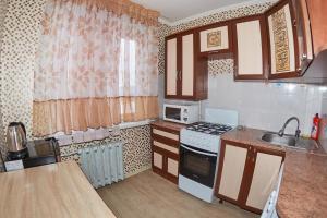 a kitchen with a sink and a stove top oven at Венеция in Petropavlovsk