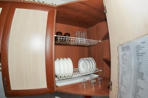 a cupboard with plates and dishes in it at Венеция in Petropavlovsk