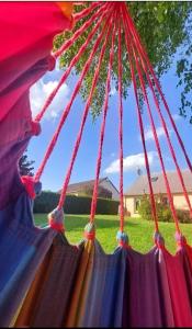 a bunch of red ropes hanging from a tent at Maison avec jardin pour 7 pers à Vibraye - Perche 2h de Paris - 45 min circuit 24h du Mans in Vibraye
