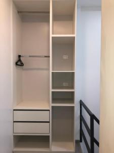 a walk in closet with white shelves at Plaza Tababela near Quito Airport in Quito