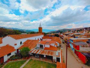 an aerial view of a town with orange roofs at Posada de San Antonio in Ráquira