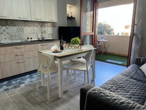a kitchen with a table and chairs in a room at Casa vacanze “Dolce sosta” in Quartu SantʼElena