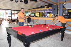 two men playing a game of pool in a bar at Side Alya Hotel in Side