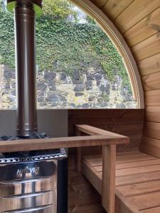 an outdoor kitchen with a stove and a window at Brecart lodge Moneyglass in Toome