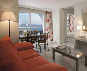 a living room with a couch and a table at Ona Marinas de Nerja Spa Resort in Nerja