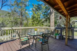 a patio with a table and chairs on a deck at Idyllic Wishon Vacation Rental about 9 Mi to Bass Lake in Bass Lake Annex