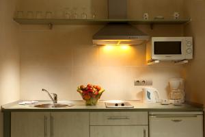 a small kitchen with a sink and a microwave at Ona Marinas de Nerja Spa Resort in Nerja