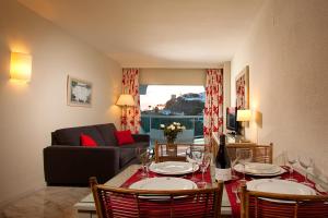a living room with a table with wine glasses on it at Marinas de Nerja Beach & Spa in Nerja