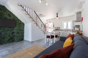 a living room with a couch and a kitchen at Mood Lodging Óbidos - Loft with mezzanine in Óbidos